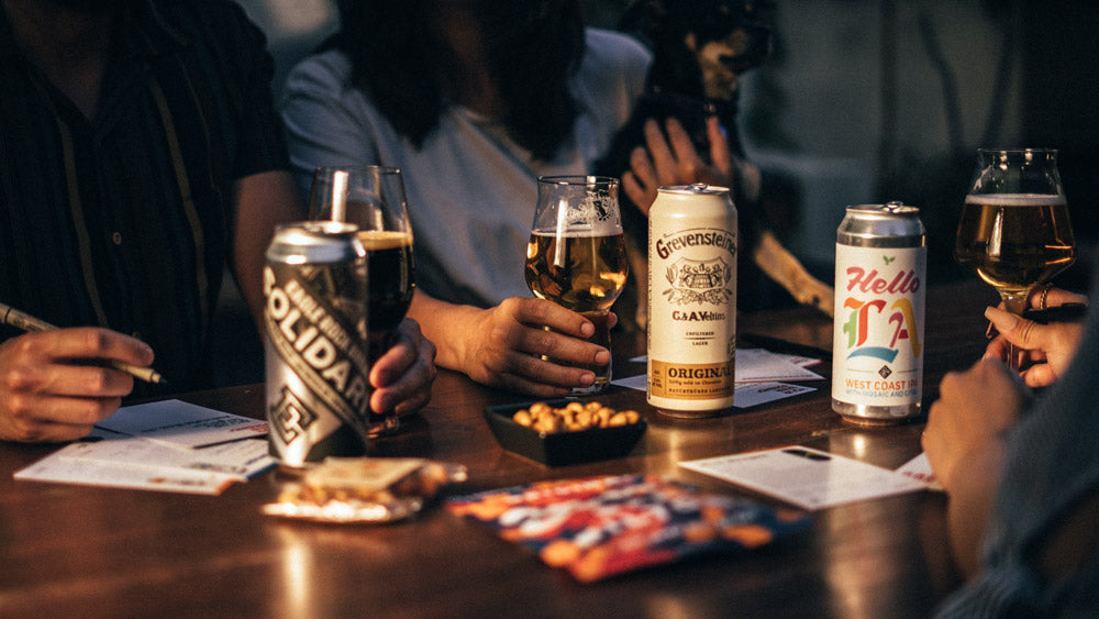 Guests raising glasses at a Your Beer Friend craft beer tasting event