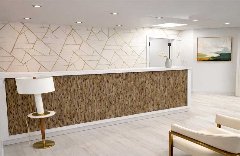Midtown East reception with gold geometric wall