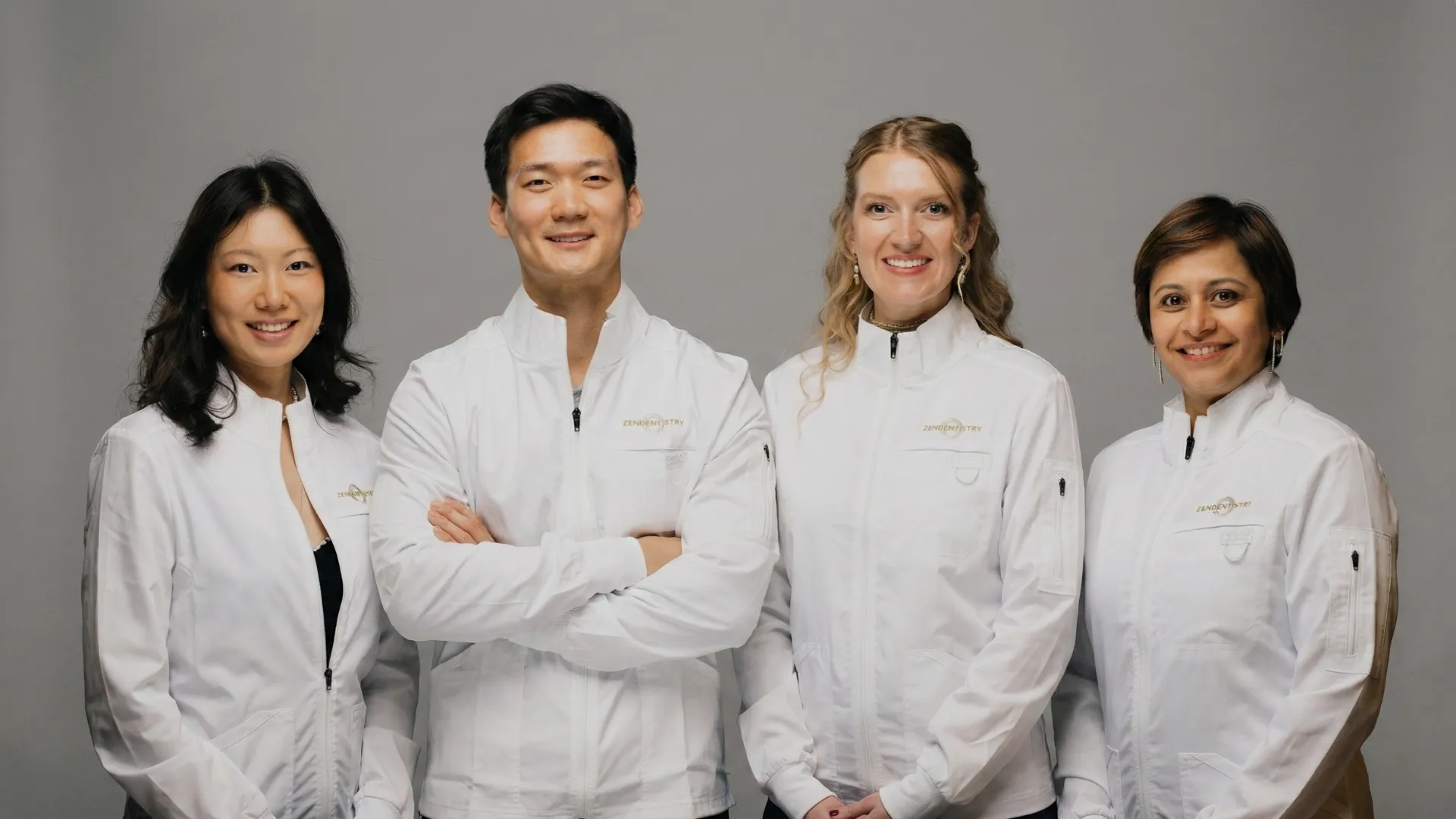 Four Zen Dentistry providers in branded white lab coats