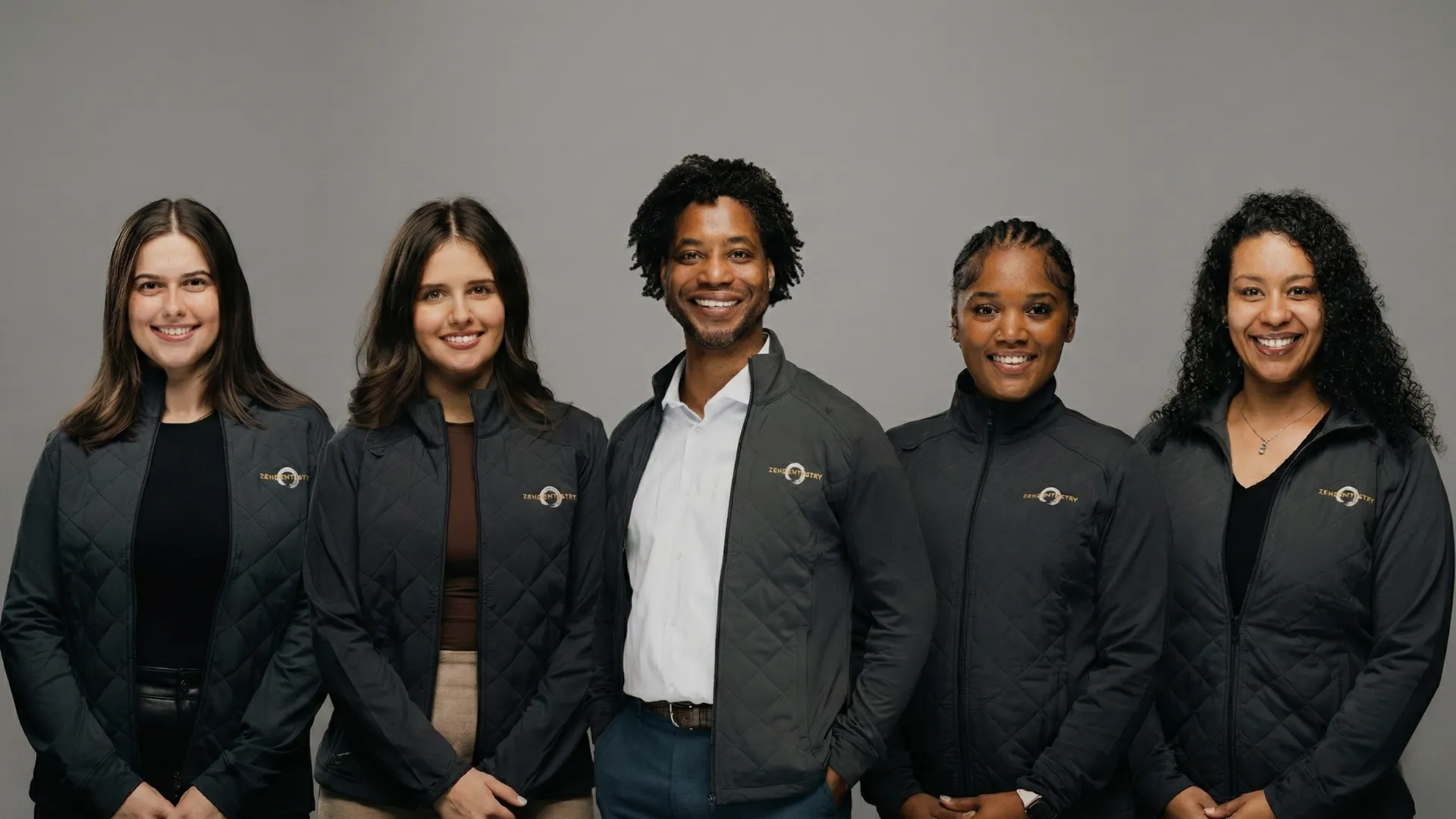 Five Zen Dentistry team members in branded jackets